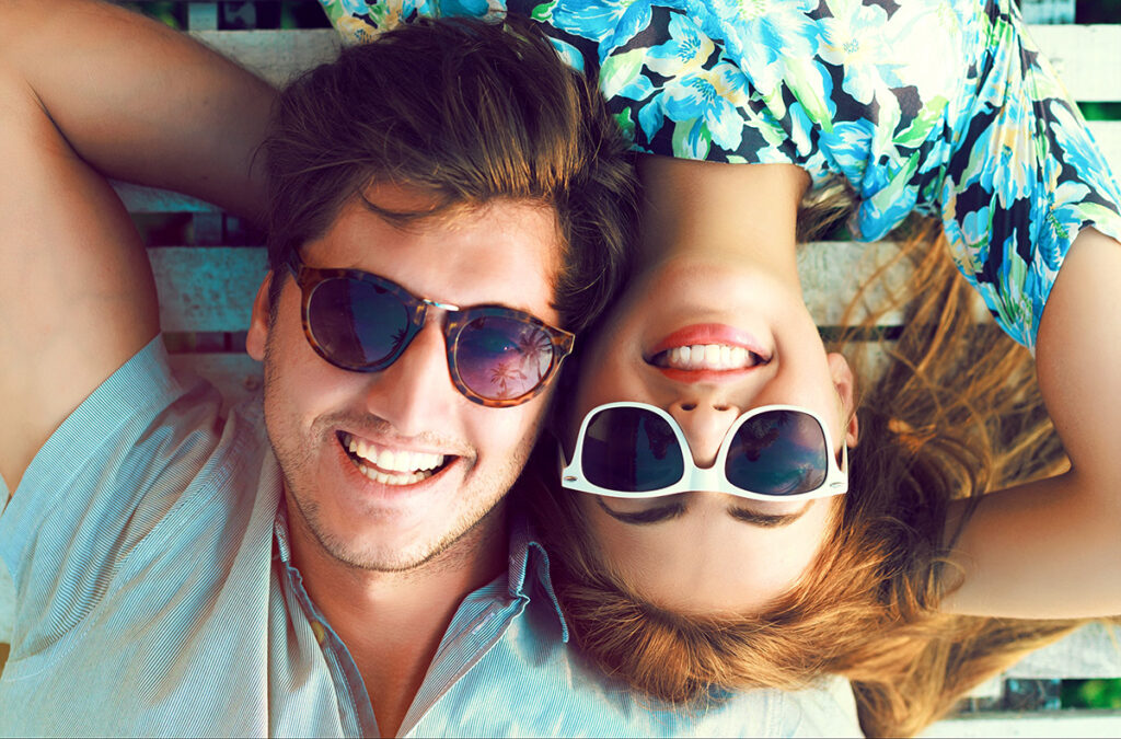 Stylish couple smiling with sunglasses on